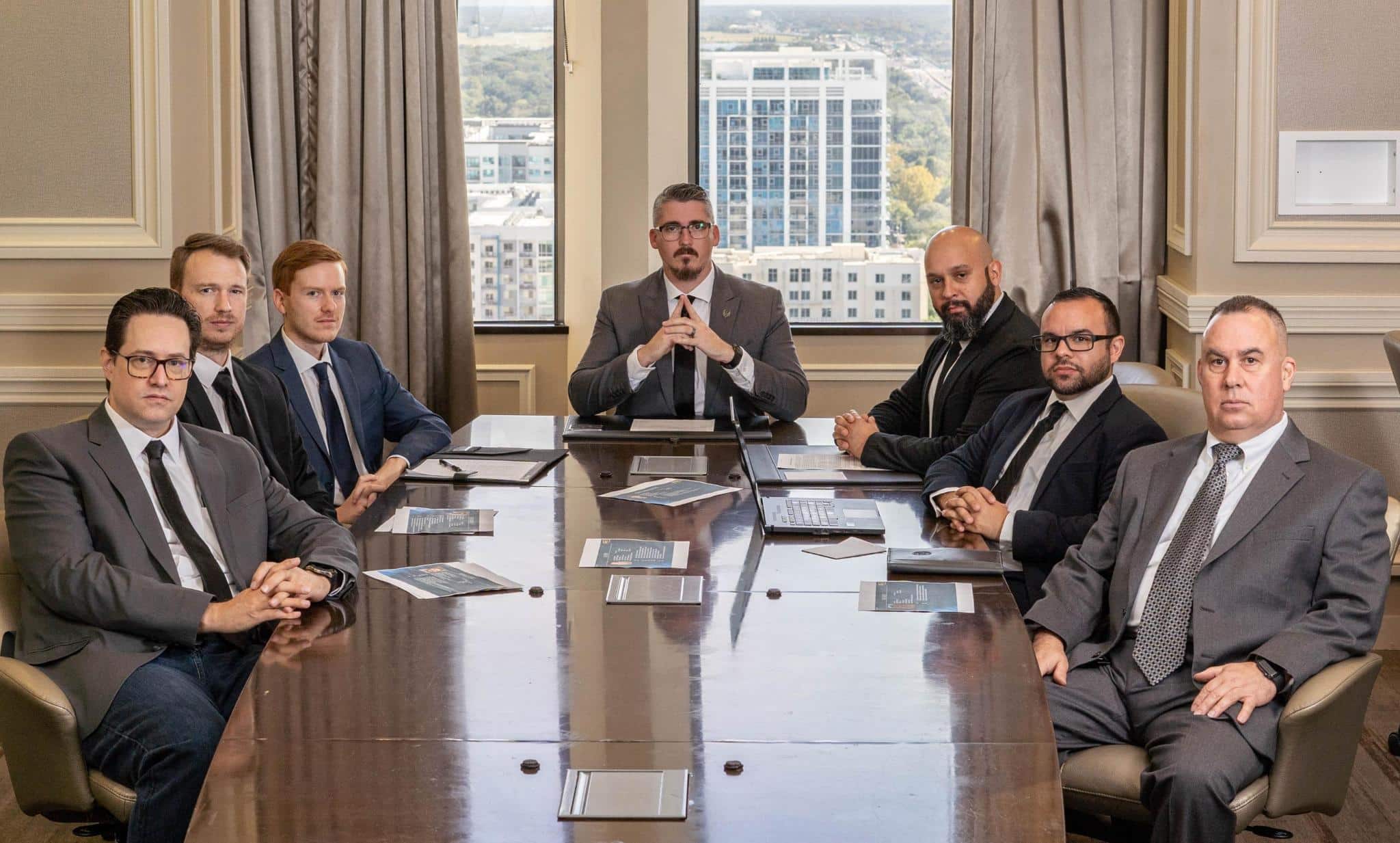 Business meeting with men around conference table.