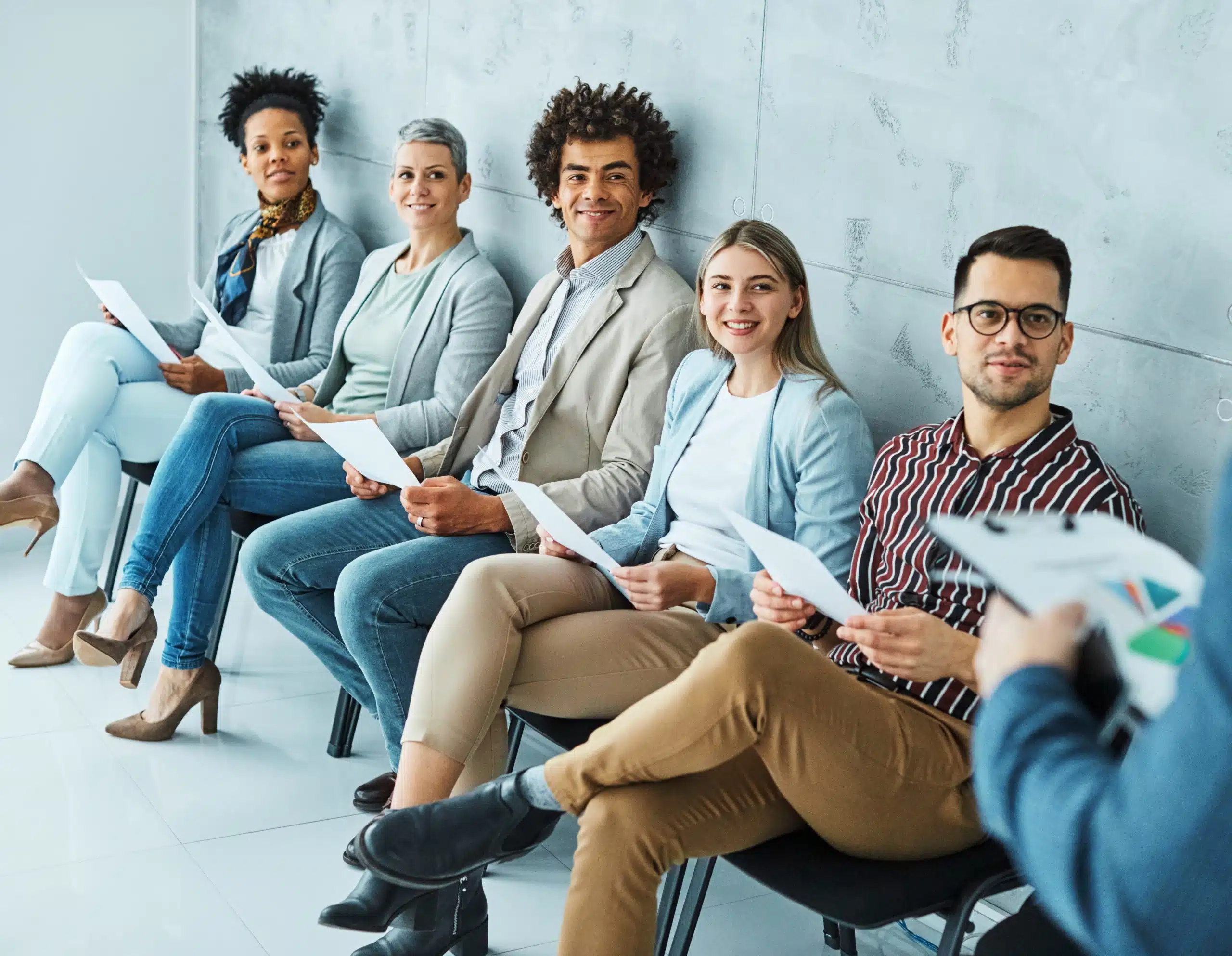 Diverse group in business meeting with papers.