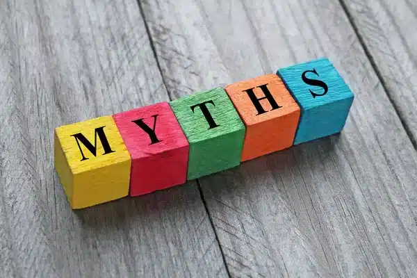 Colorful blocks spelling 'MYTHS' on wood background.