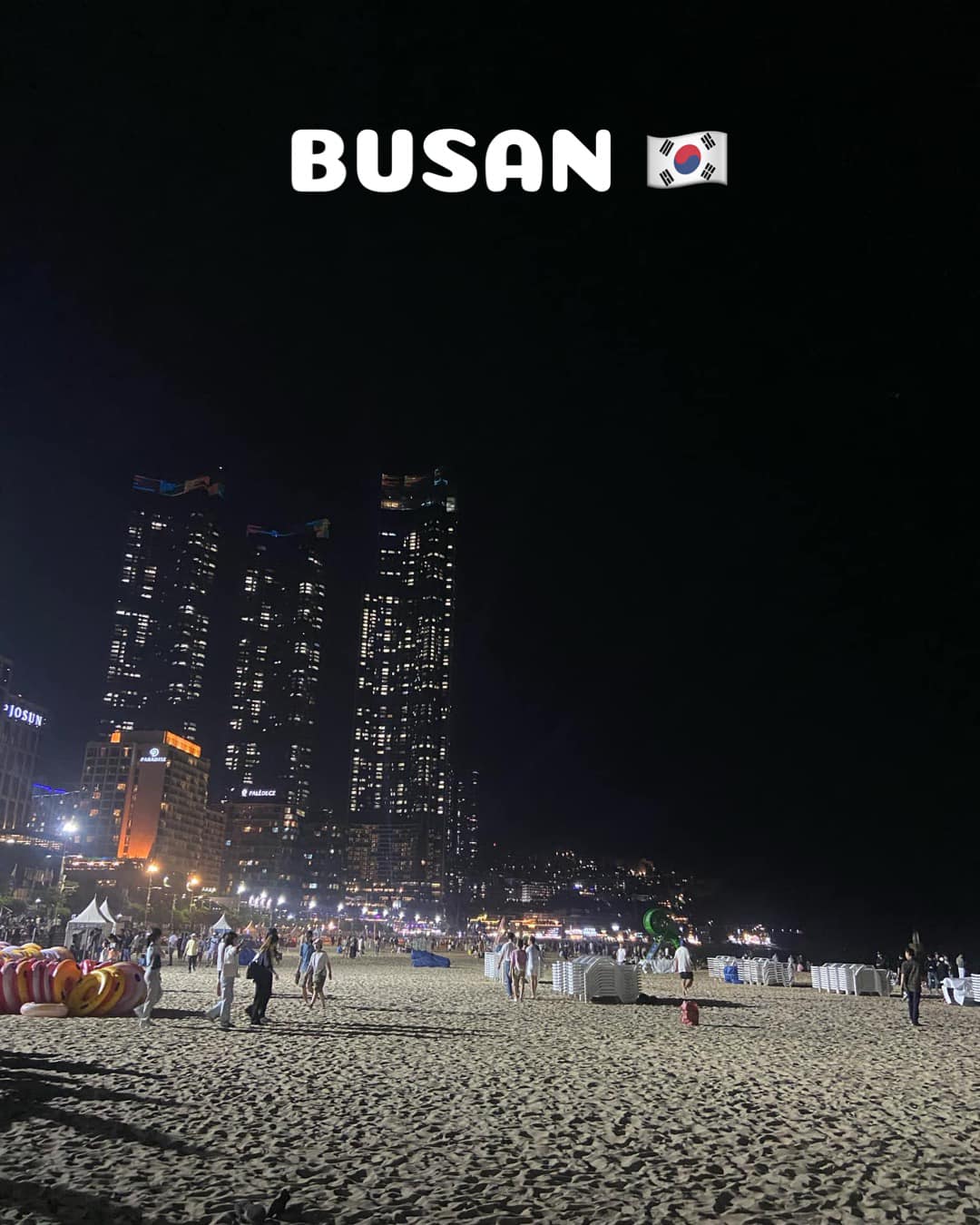 Night view of Busan beach and city lights.