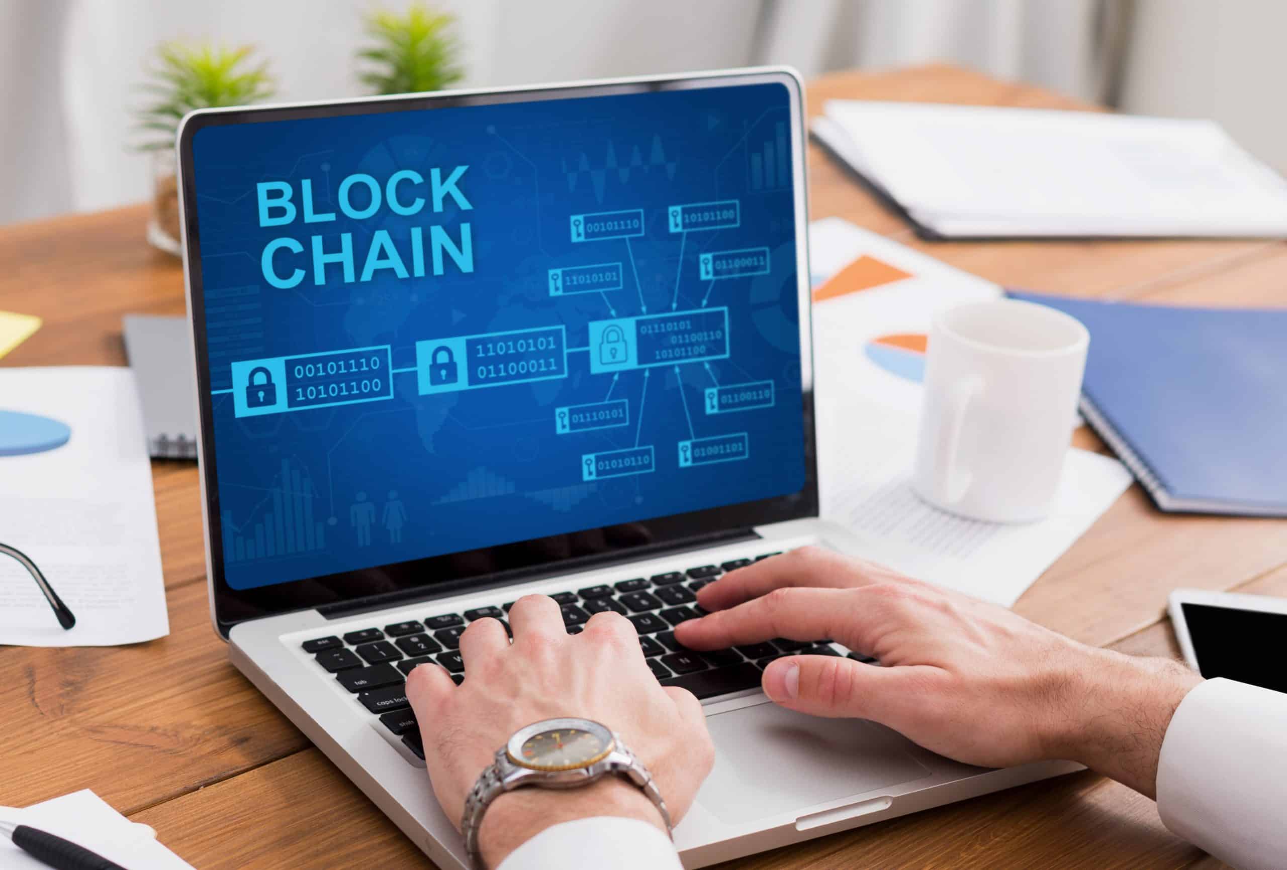 Person working on blockchain laptop