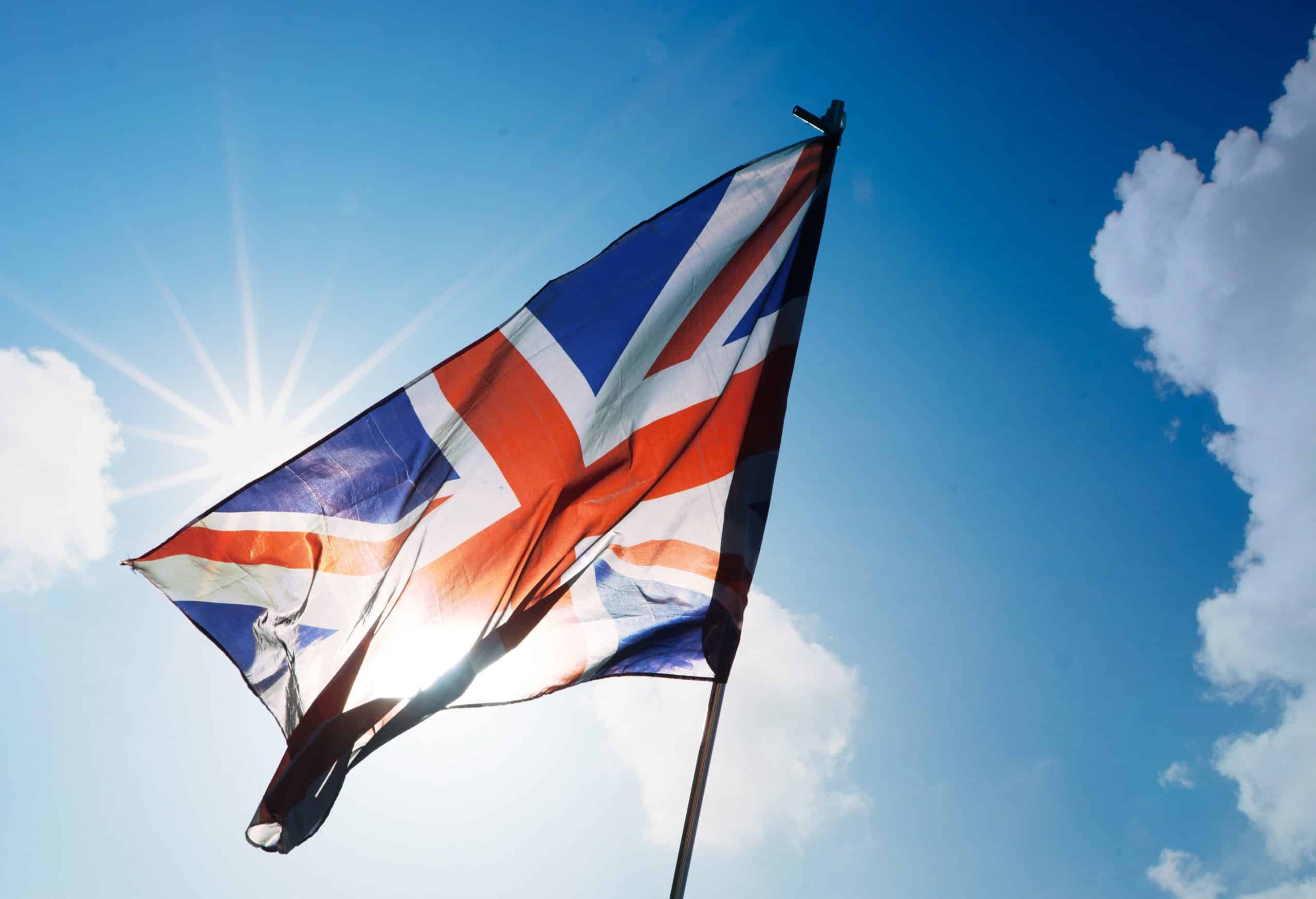 Union Jack flag waving against bright sky