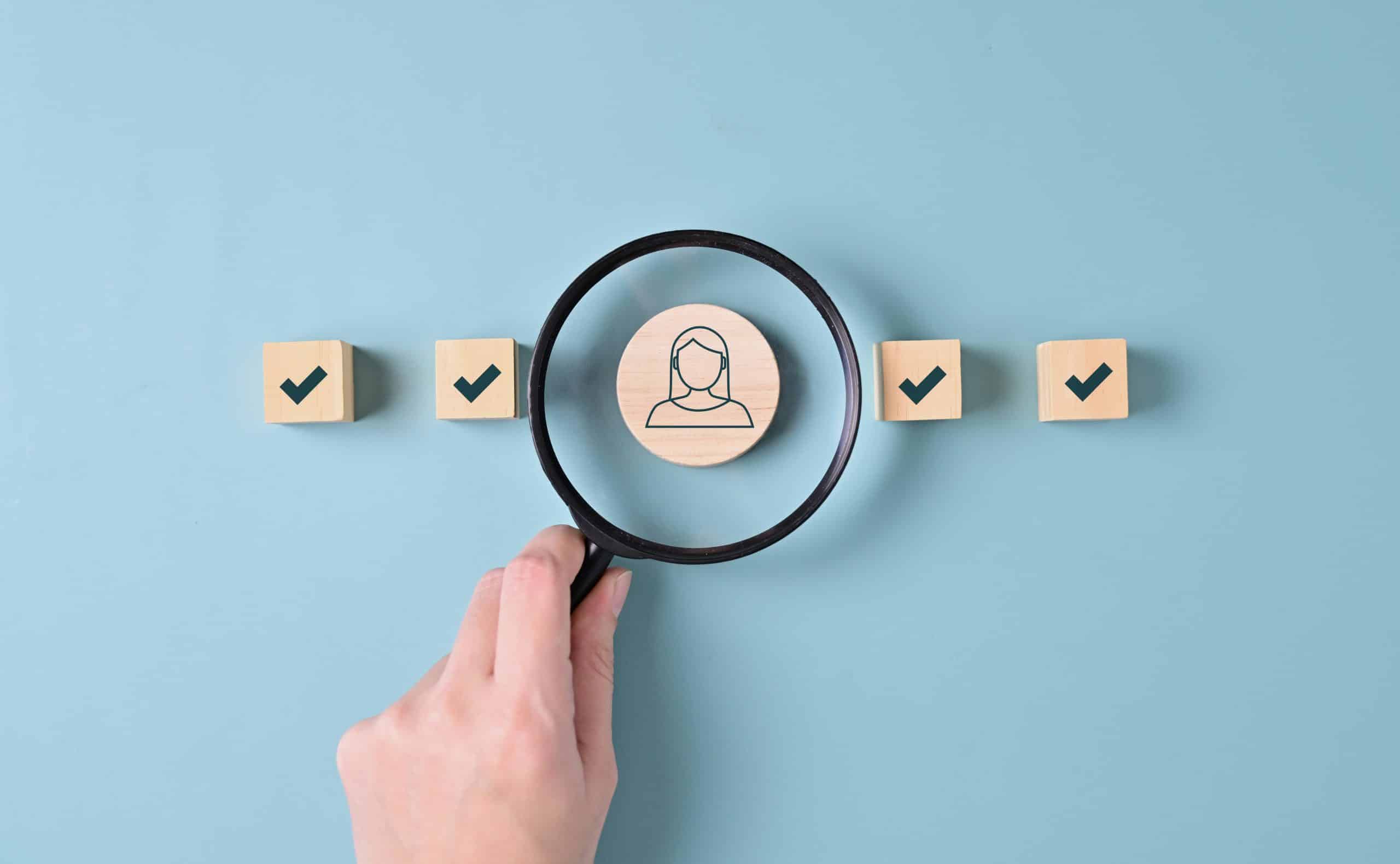 Employee selection concept with magnifying glass.